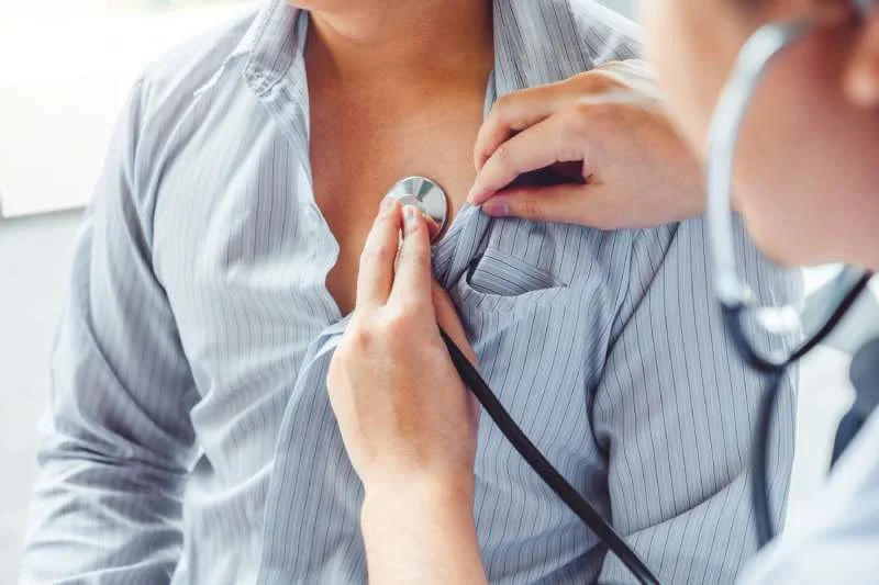 Cardiologist performing a heart exam using a stethoscope at Magnet Health NY, 907 E Tremont Ave, Bronx, NY 10460