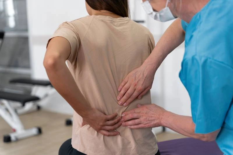 Physician treating lower back pain from herniated disc at Magnet Health NY, 741 E 233rd St, Bronx, NY 10466